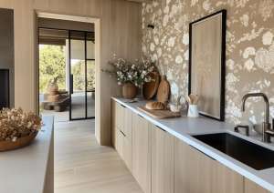 An-array-of-vintage-glassware-on-modern-shelves-brings-character-to-this-eclectic-kitchen